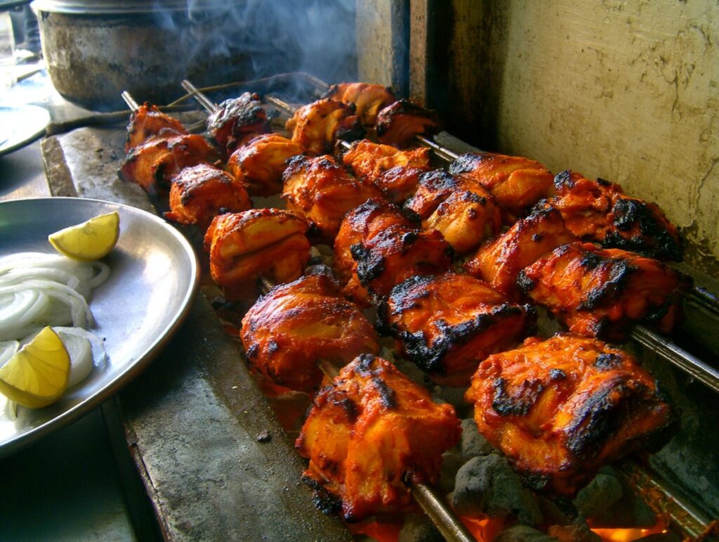Tandoori chicken — bone-in chicken in spiced yogurt, charred in the tandoor, Delhi, Mughal Corridor